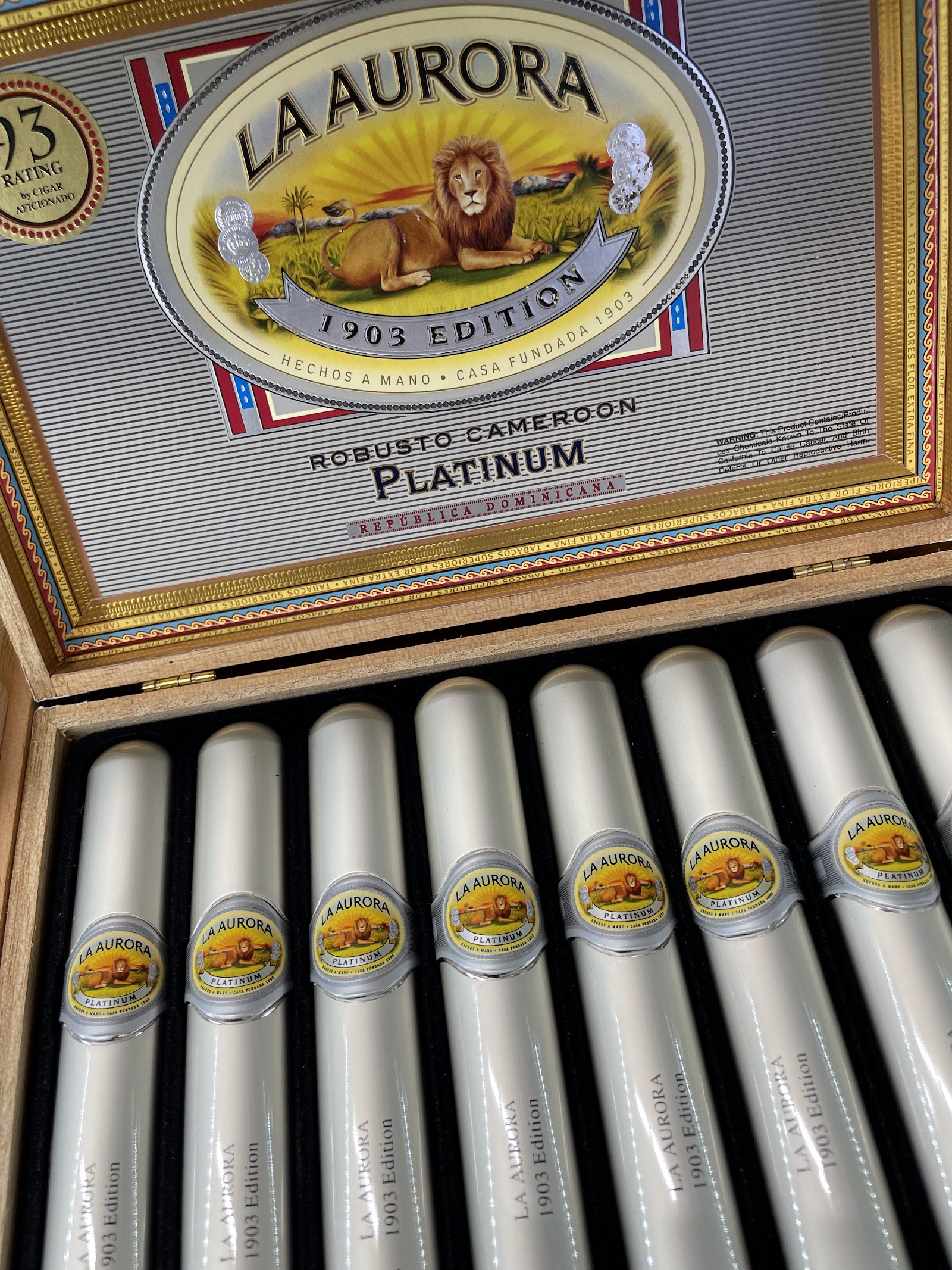 La Aurora 1903 Edition Robusto Cameroon Platinum cigars in silver-capped aluminum tubes.